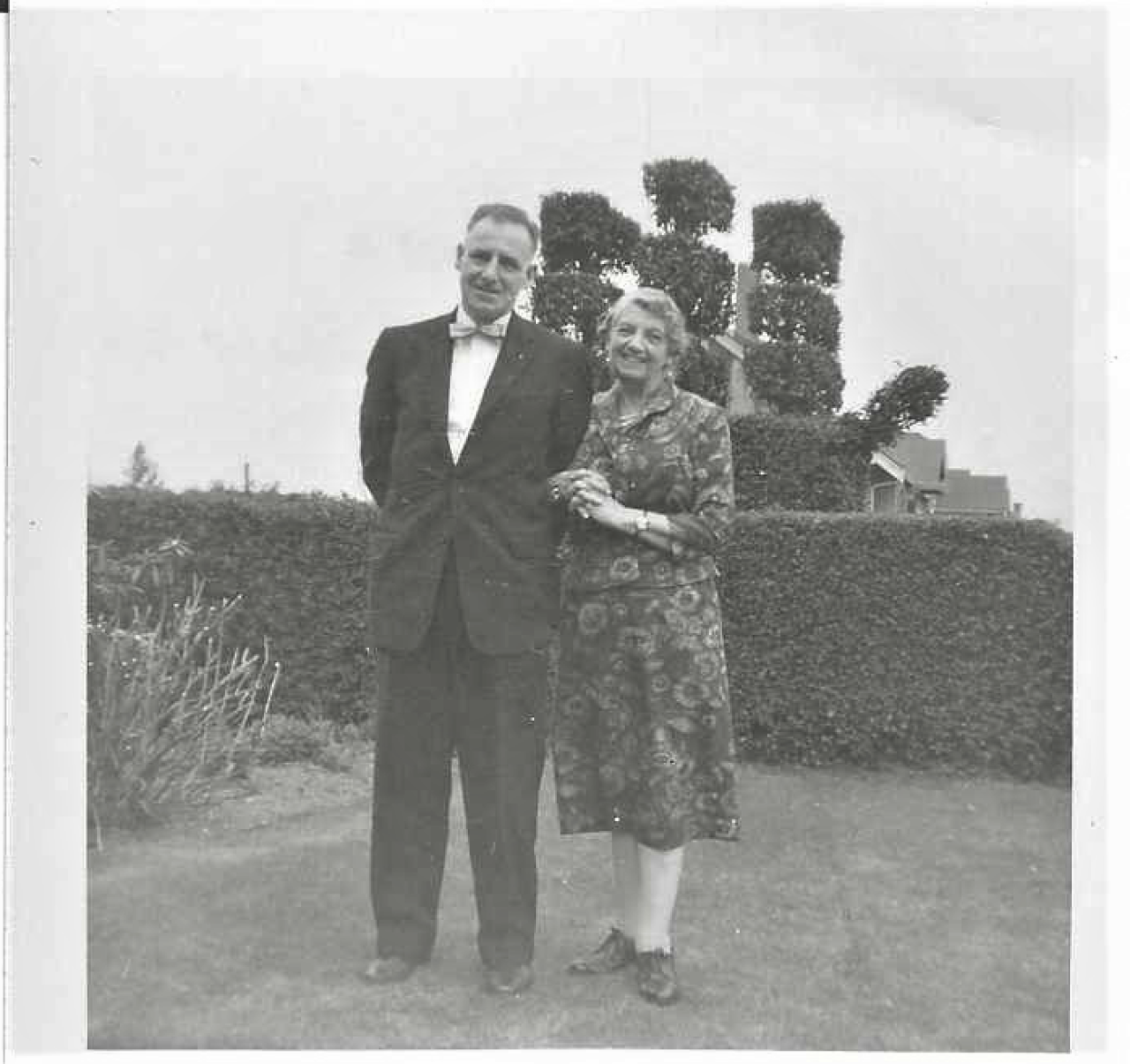 John O. Little and Jennie Harrison in front of holly hedge. Personal collection of John Little.